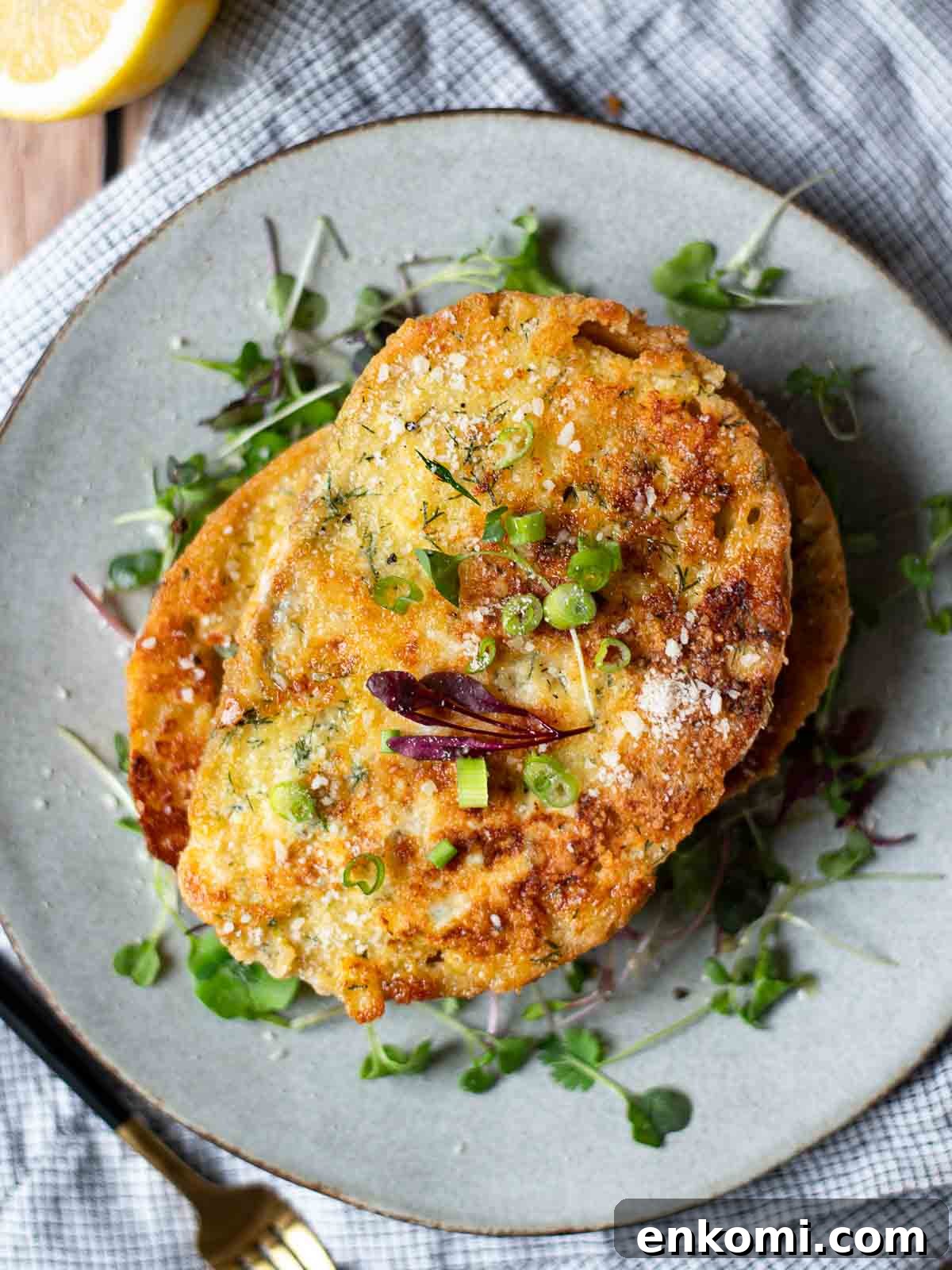 Parmesan, Lemon & Herb Savory French Toast Recipe 3 Overhead of savory French toast over a bed of microgreens on a grey plate.