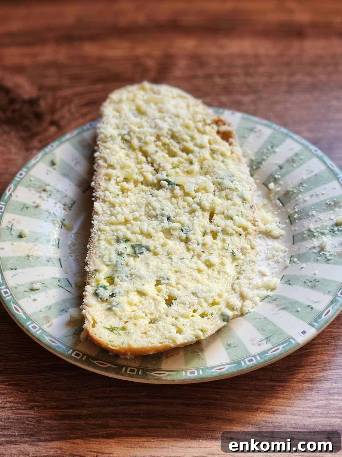 Parmesan, Lemon & Herb Savory French Toast Recipe 7 Bread dipped in parmesan cheese on a green plate.