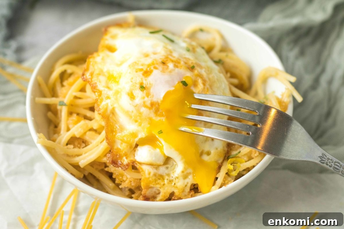 oozing egg yolk of a fried egg over pasta pangrattato