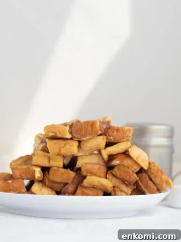 a pile of french toast sticks on a white plate