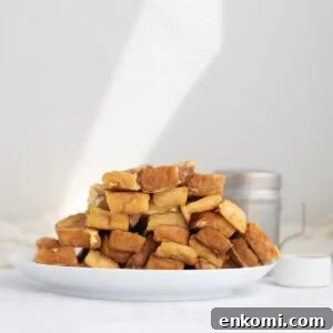 a pile of french toast sticks on a white plate