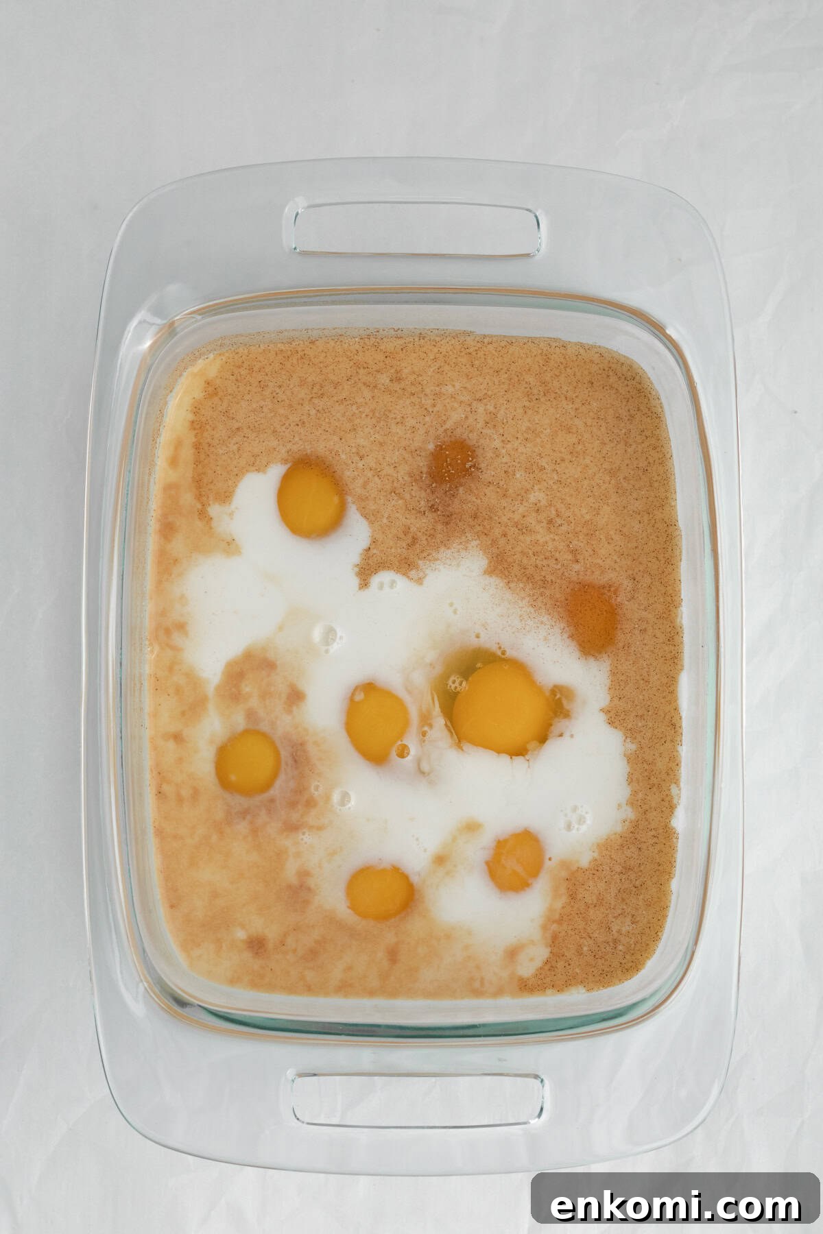 eggs, milk and cinnamon sugar in a glass mixing dish
