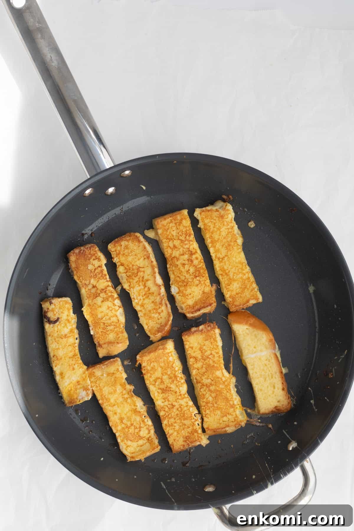 french toast sticks cooking in a pan