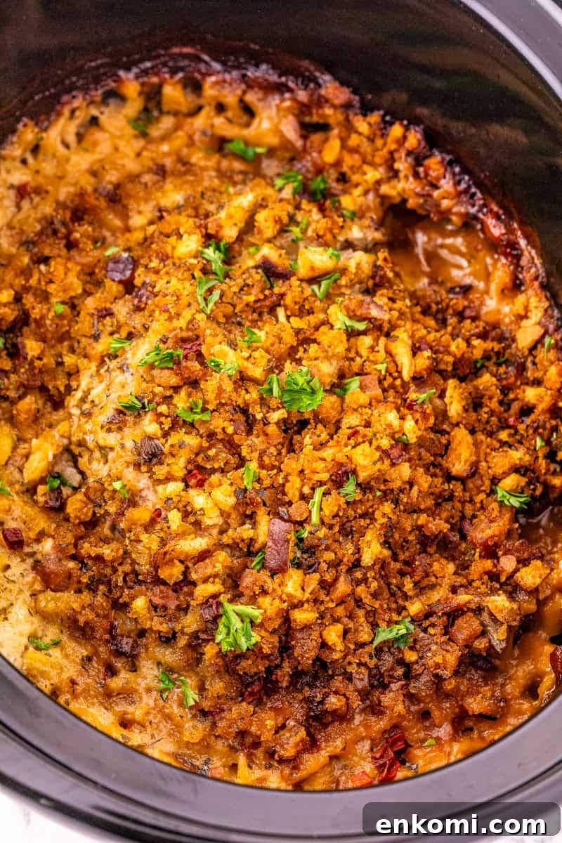 pork chops and stuffing in a black crock pot.