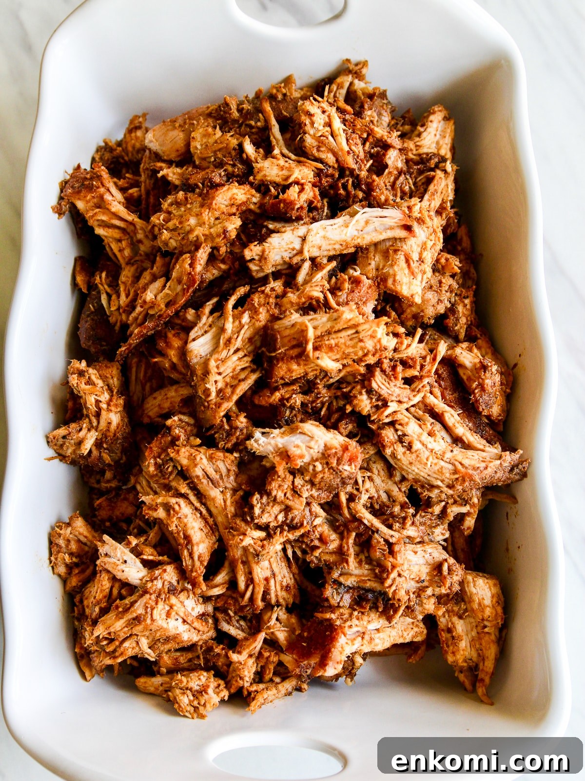 Juicy Oven-Roasted Pulled Pork 2 Oven roasted pulled pork in a white dish