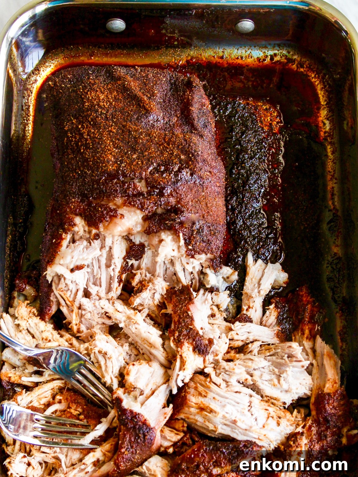 Juicy Oven-Roasted Pulled Pork 10 Pulling pork with two forks