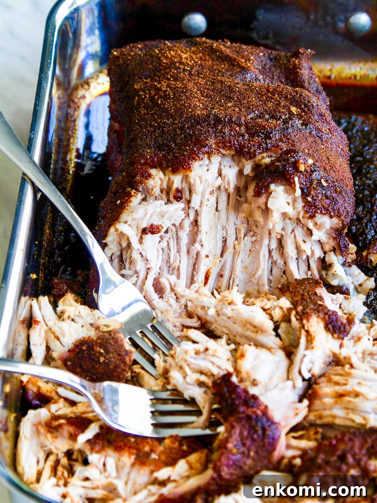 Juicy Oven-Roasted Pulled Pork 11 Shredding and pulling pork with two forks