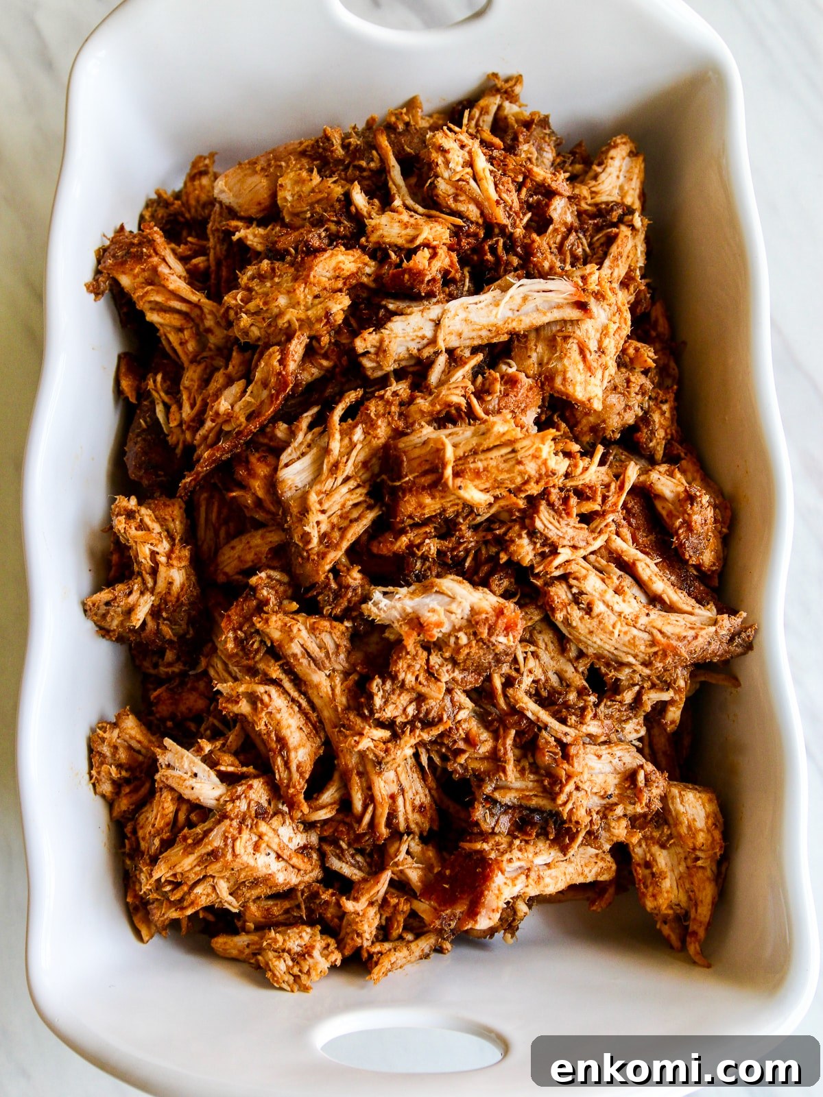 Juicy Oven-Roasted Pulled Pork 12 Pulled pork in white dish