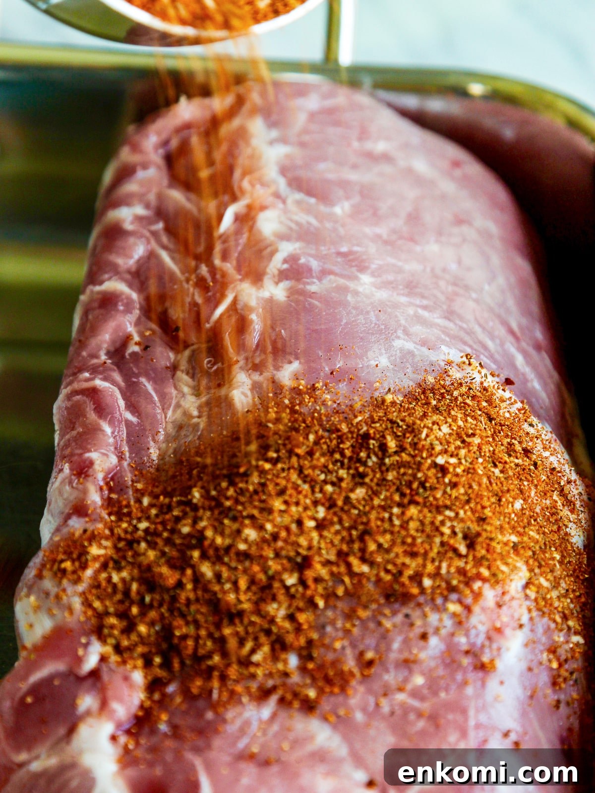 Juicy Oven-Roasted Pulled Pork 4 Pork loin with BBQ rub pouring on top