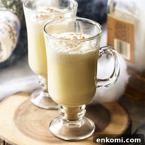 Homemade hot bourbon eggnog is easy to make and will warm you right through. I think it's the perfect drink for cold and snowy days by the fire! | justalittlebitofbacon.com