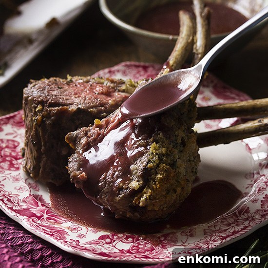 For the best herb crusted rack of lamb, marinate it overnight, cover in breadcrumbs, oven roast, and pair it with with a silky red wine sauce. This elegant recipe is perfect for the holidays or for a dinner party any time of the year. | justalittlebitofbacon.com