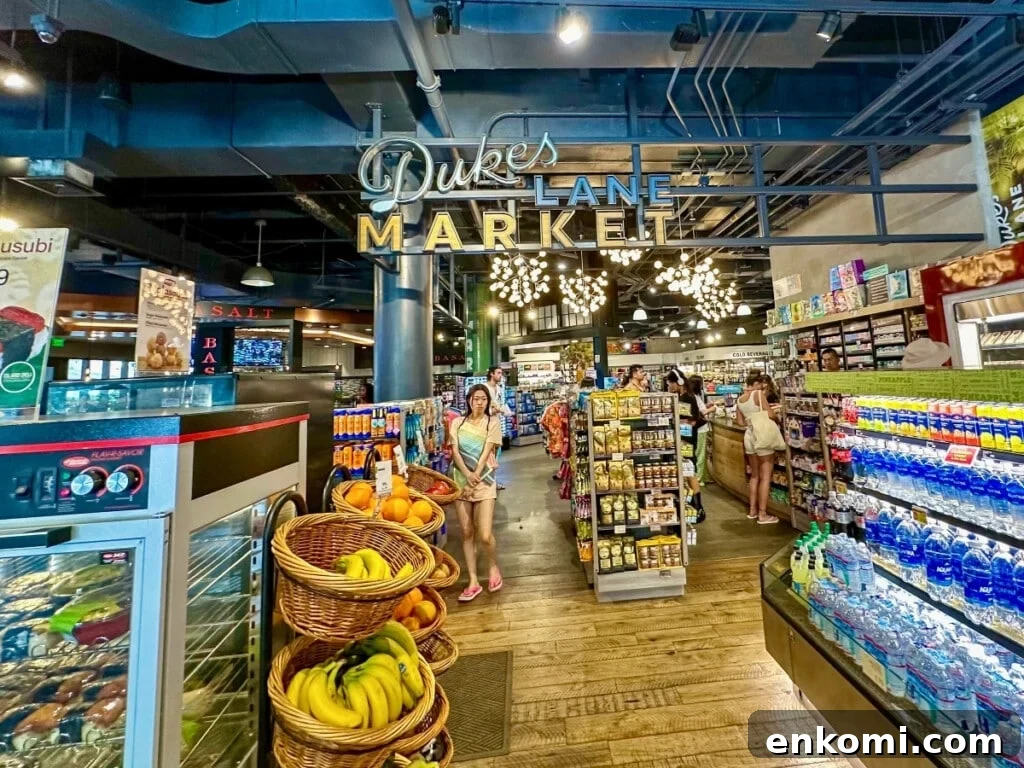 Inside Dukes Lane Market & Eatery in Waikīkī featuring fresh fruit displays, grocery items and everyday essentials.