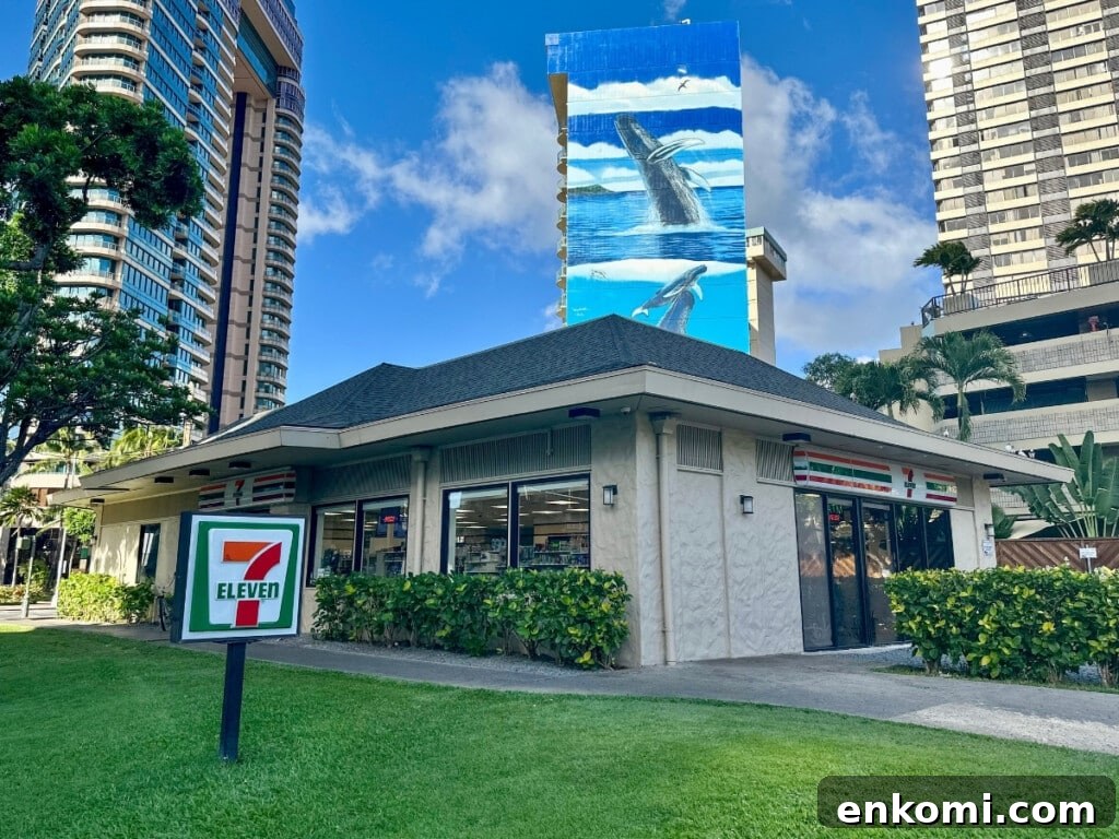 Exterior of 7-Eleven in Waikīkī with high-rise buildings and palm trees in the background.
