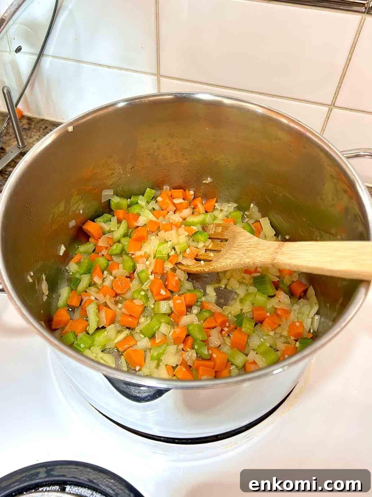 aromatics being cooked in large pot.