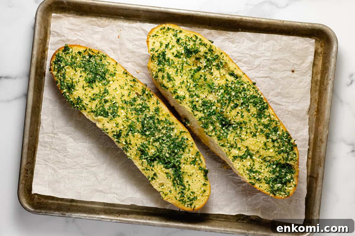 Baking sheet with freshly made garlic bread