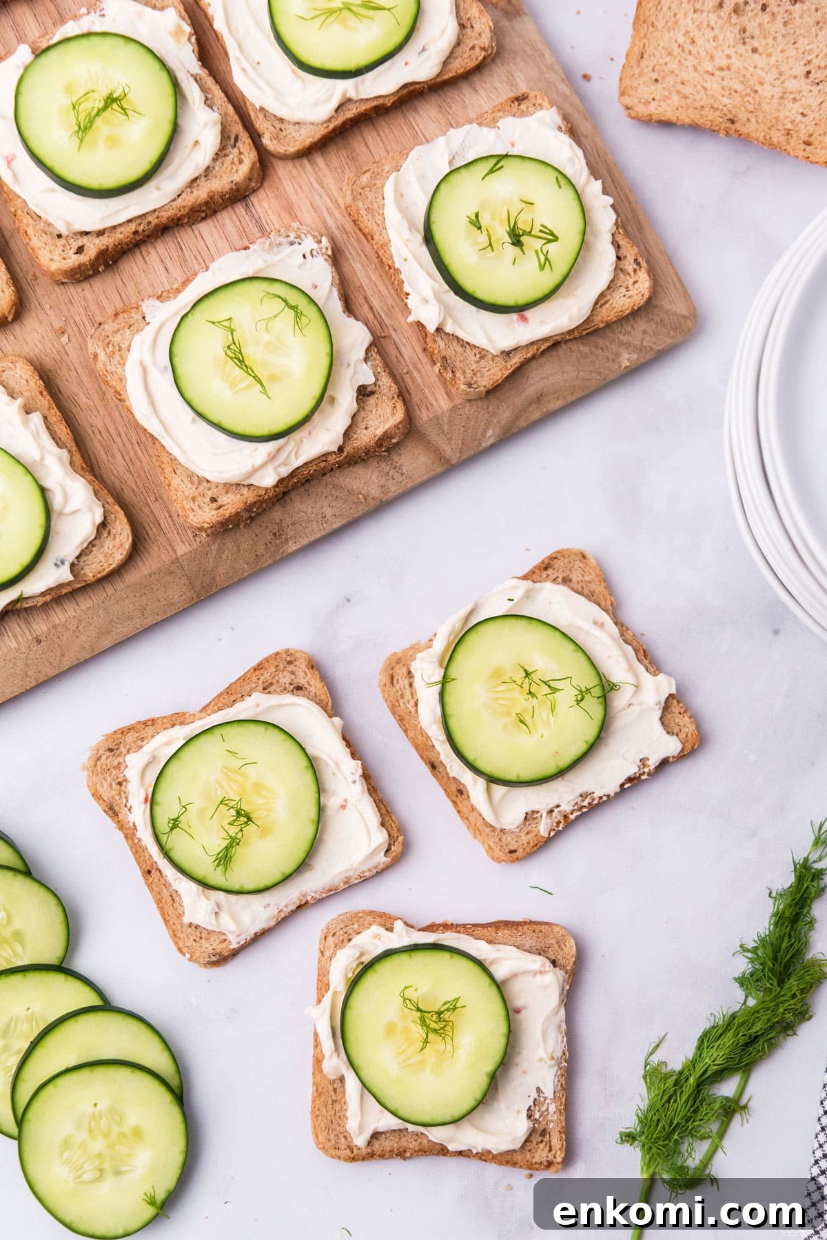 Mini Cucumber Tea Sandwiches for Parties and Picnics 2 MINI CUCUMBER SANDWICHES ON A WOOD BOARD