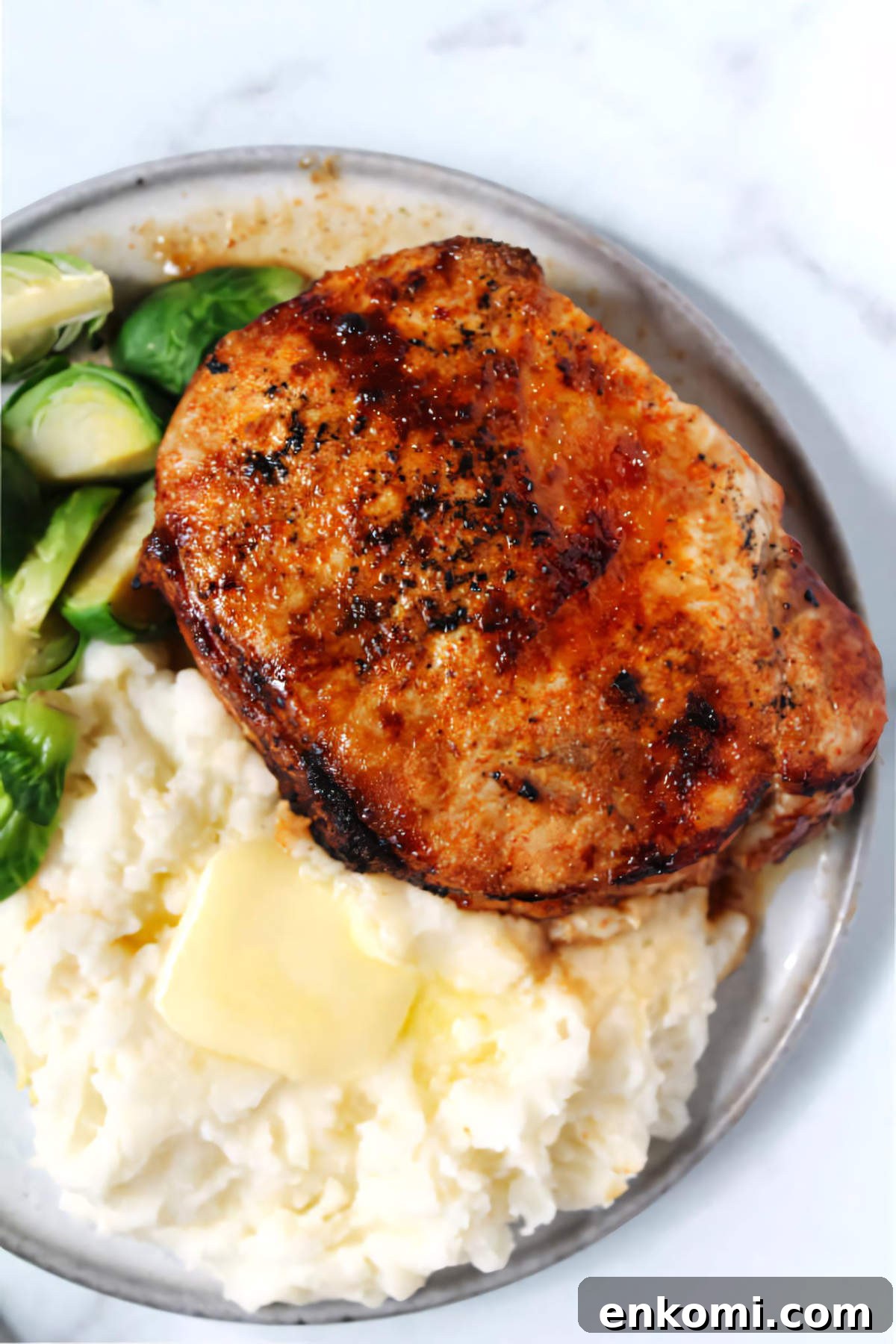 Pork Loin vs Pork Chop: Which Cut Should You Cook? 4 Chipotle crusted pork chop plated with mashed potatoes and Brussels sprouts.