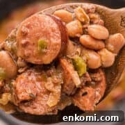 Crockpot beans on a wooden spoon.