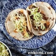 Two tacos made with ground venison on a blue plate