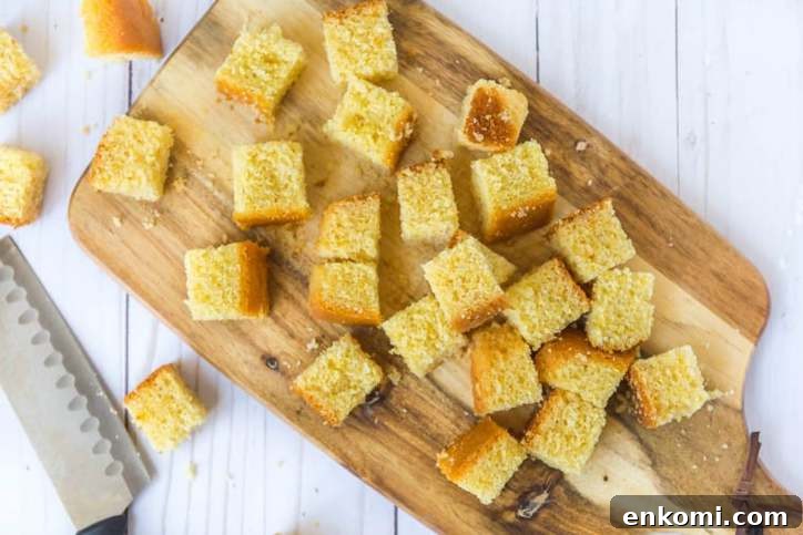 Classic Southern Cornbread Salad Recipe 3 The cornbread cut into cubes on a cutting board
