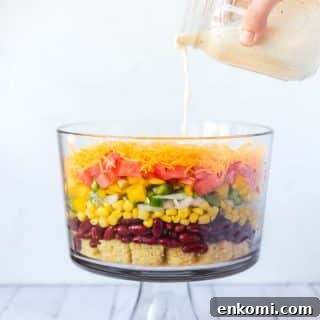 Classic Southern Cornbread Salad Recipe 8 The ranch dressing being poured over the top of the Southern Cornbread Salad