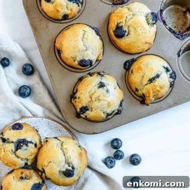 completed blueberry banana muffins in tin and plated against white surface
