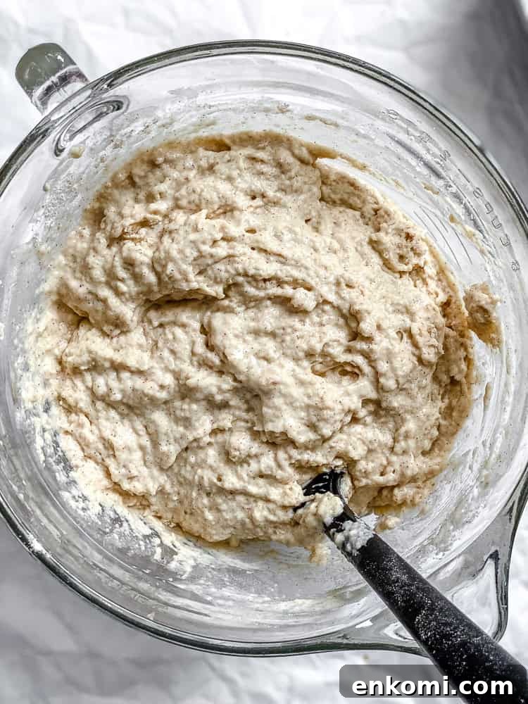 Process shot showing mixing batter in a bowl.