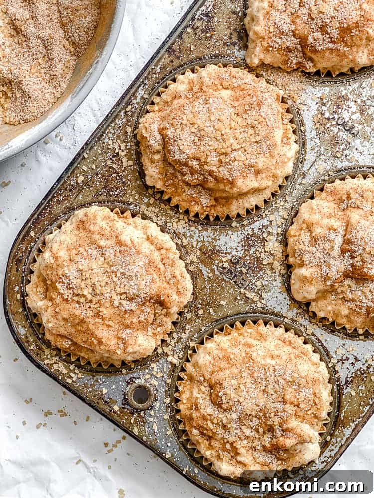 Process shot showing pre-baked muffins in muffin tin.