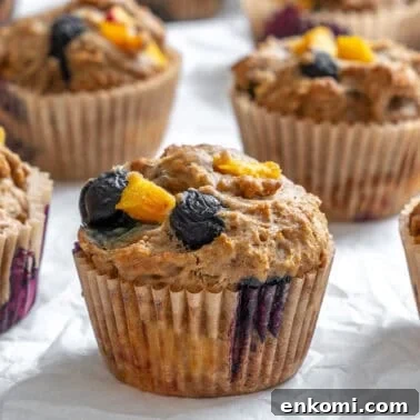 completed Blueberry Peach Muffins on white surface