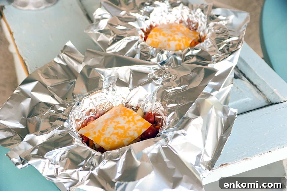 cheese slices on top of hobo stew ingredients.