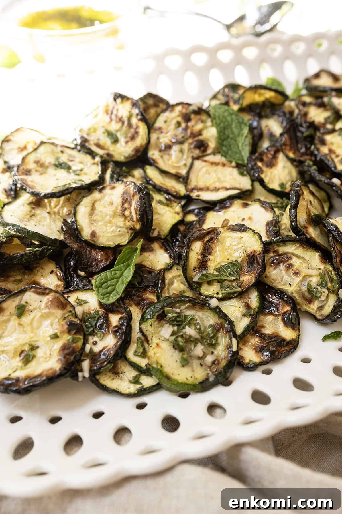 Zucchini alla scapece on a tray garnished with mint.