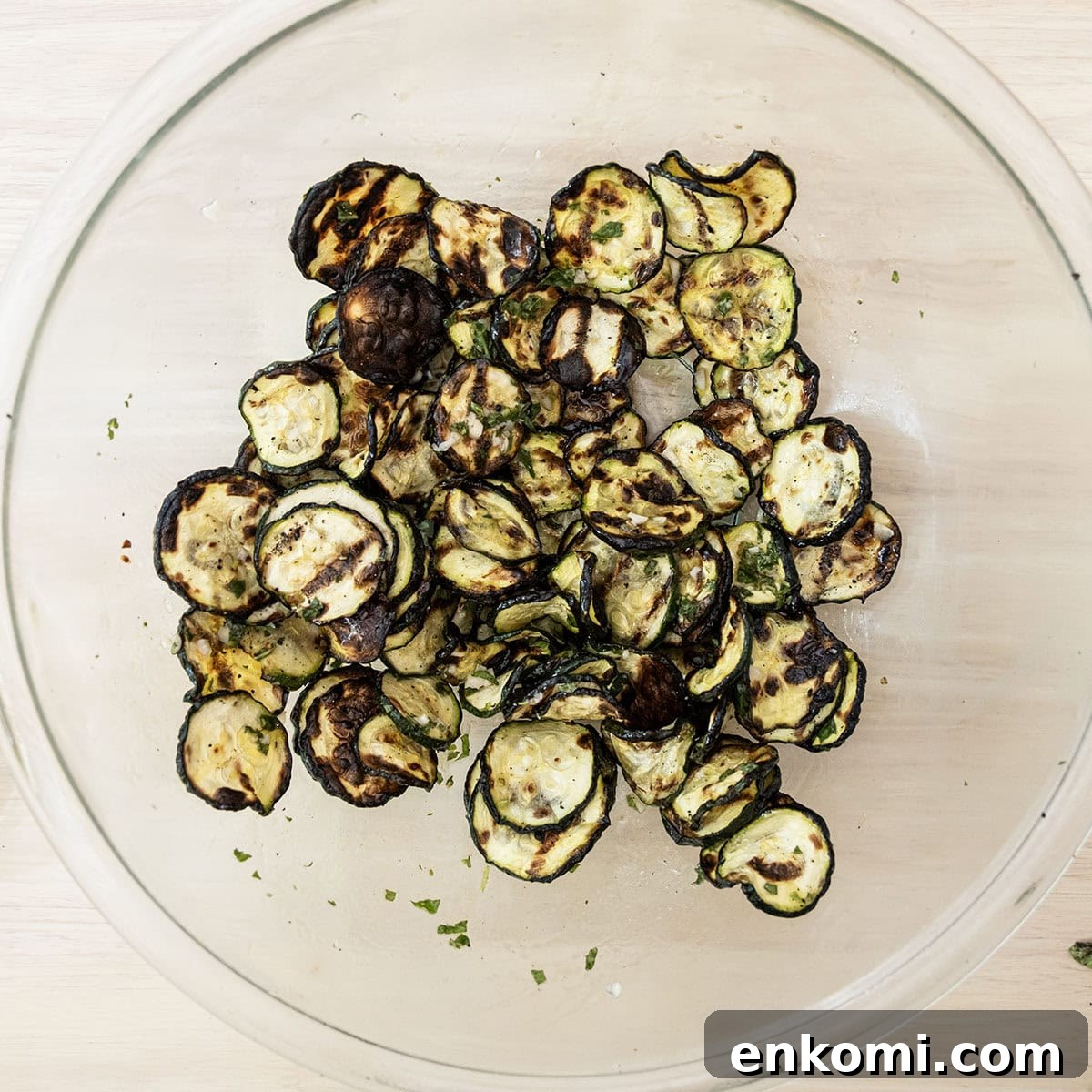 Grilled zucchini in a bowl tossed with mint dressing.