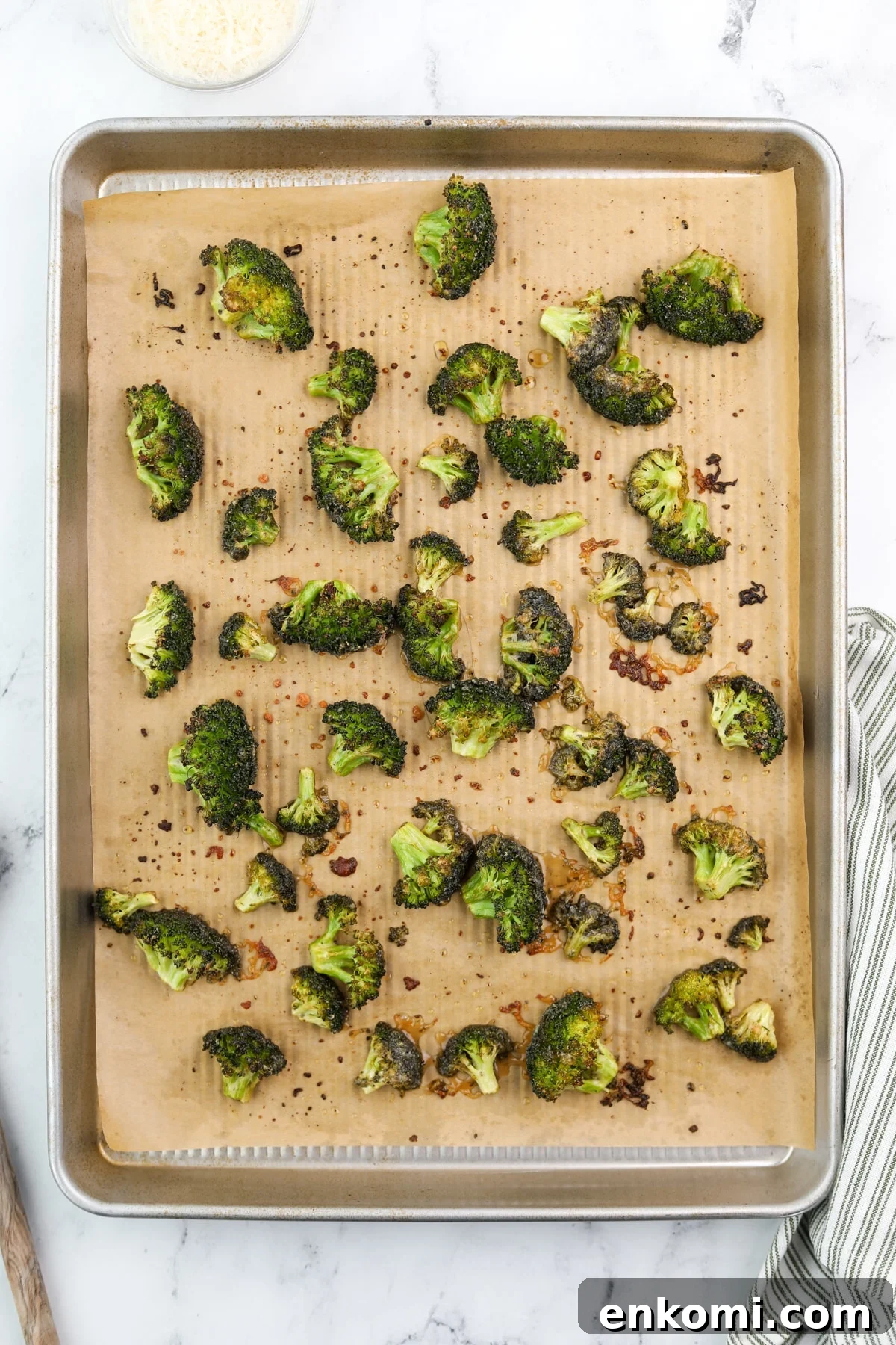 Roasted broccoli on a baking sheet.
