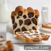 Sliced leopard bread on a white cutting board.