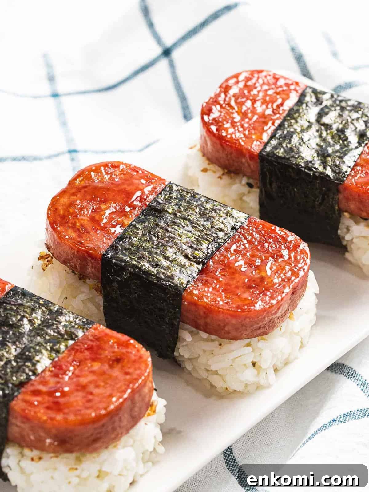 Authentic Hawaiian Spam Musubi Recipe 2 Spam musubi with rice, fried spam, and nori seaweed.