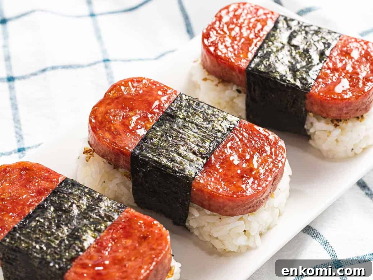 Authentic Hawaiian Spam Musubi Recipe 7 Three pieces of spam musubi glazed with teriyaki sauce.