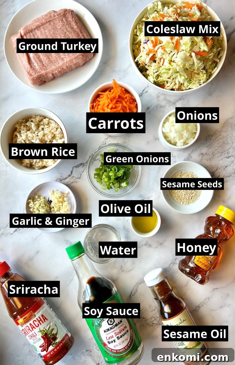 One-Pan Egg Roll Bowls with Ground Pork and Cabbage 2 Ingredients list for one-pan egg roll bowls. ground turkey, onions, garlic, ginger, carrots, coleslaw mix, olive oil, brown rice, water, honey, sesame oil, soy sauce, siracha, and sesame seeds.