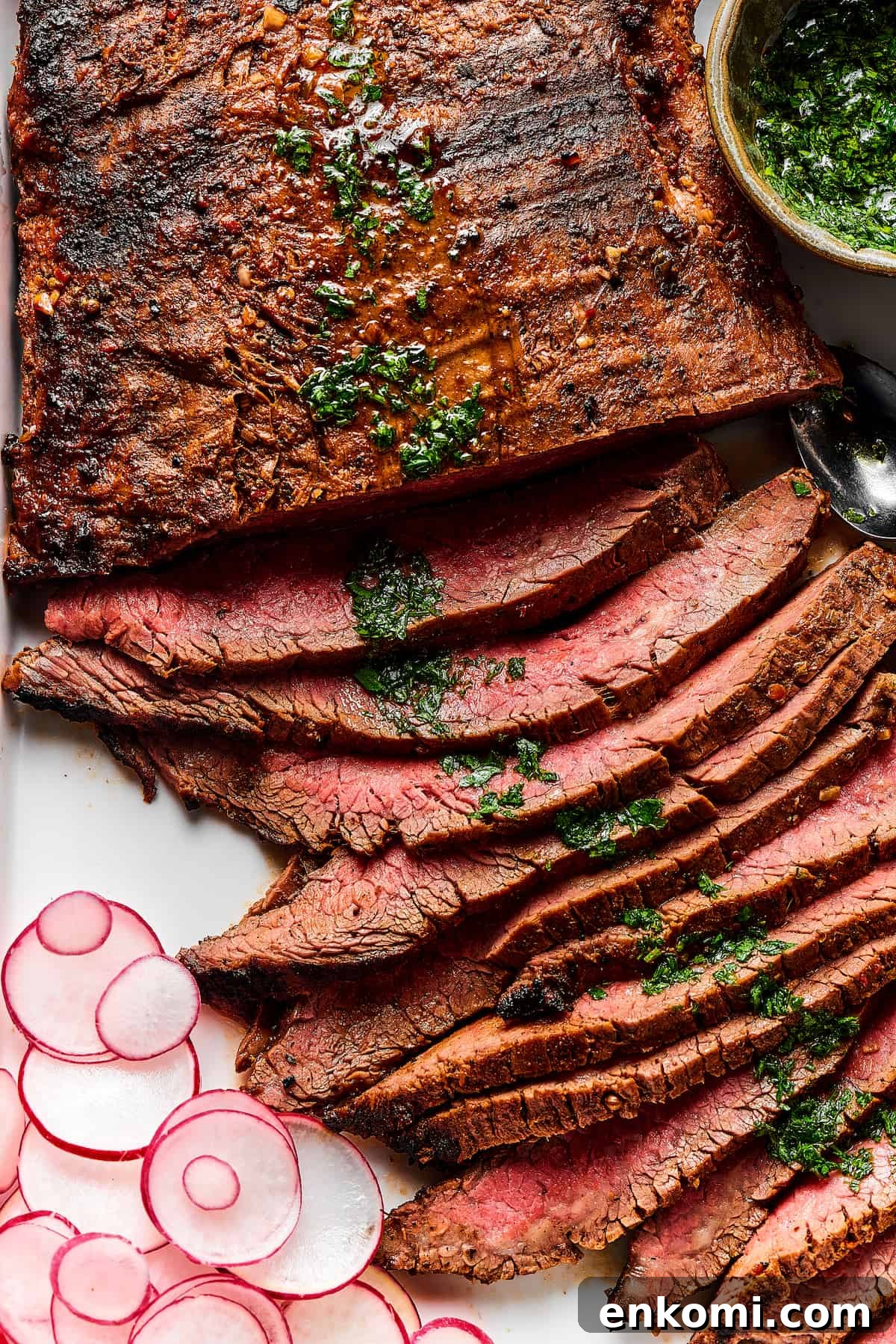 Thinly sliced grilled carne asada on a serving platter.