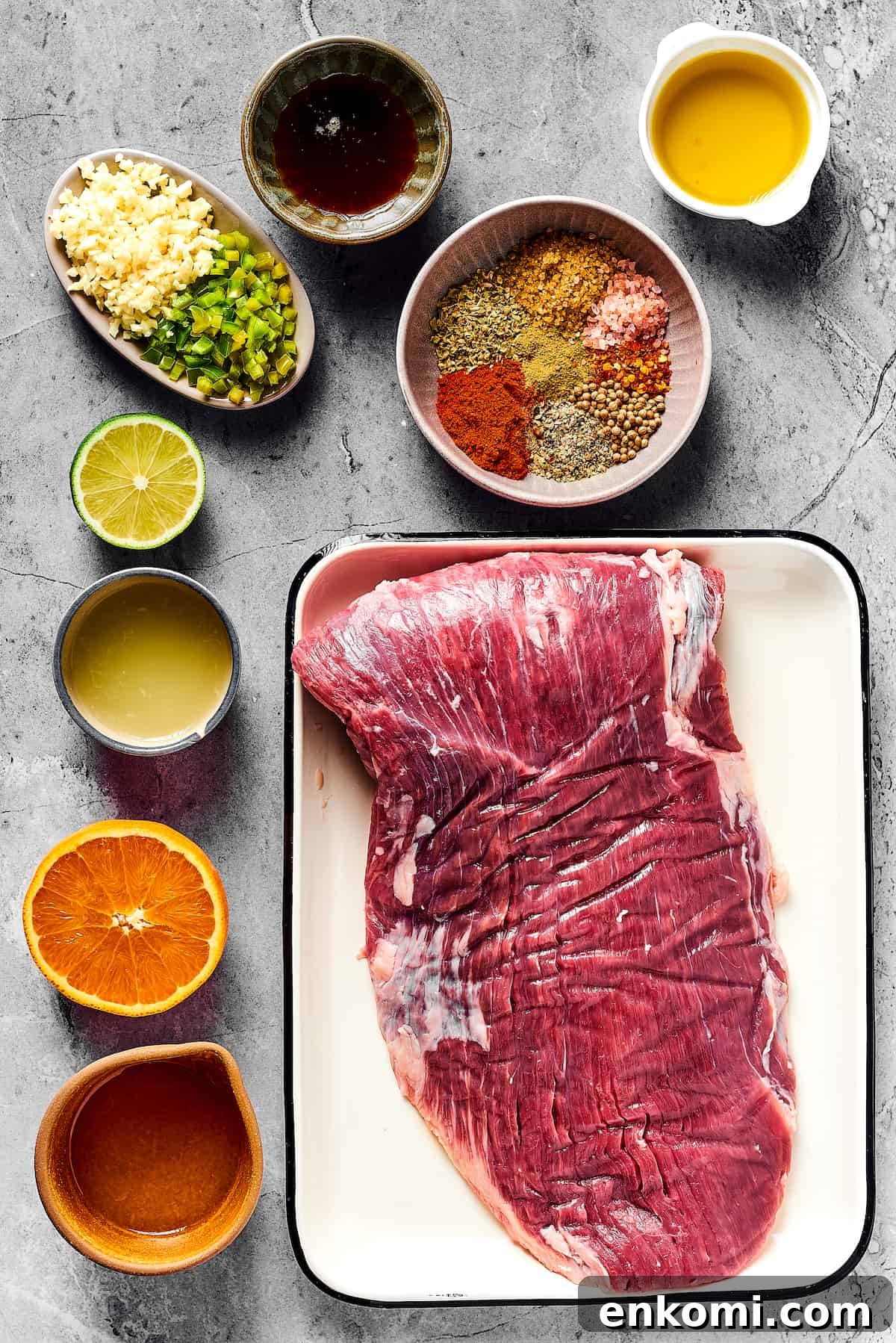 From top left: Minced garlic and jalapeno, maple syrup, spices, olive oil, lime juice, orange juice, flank steak.