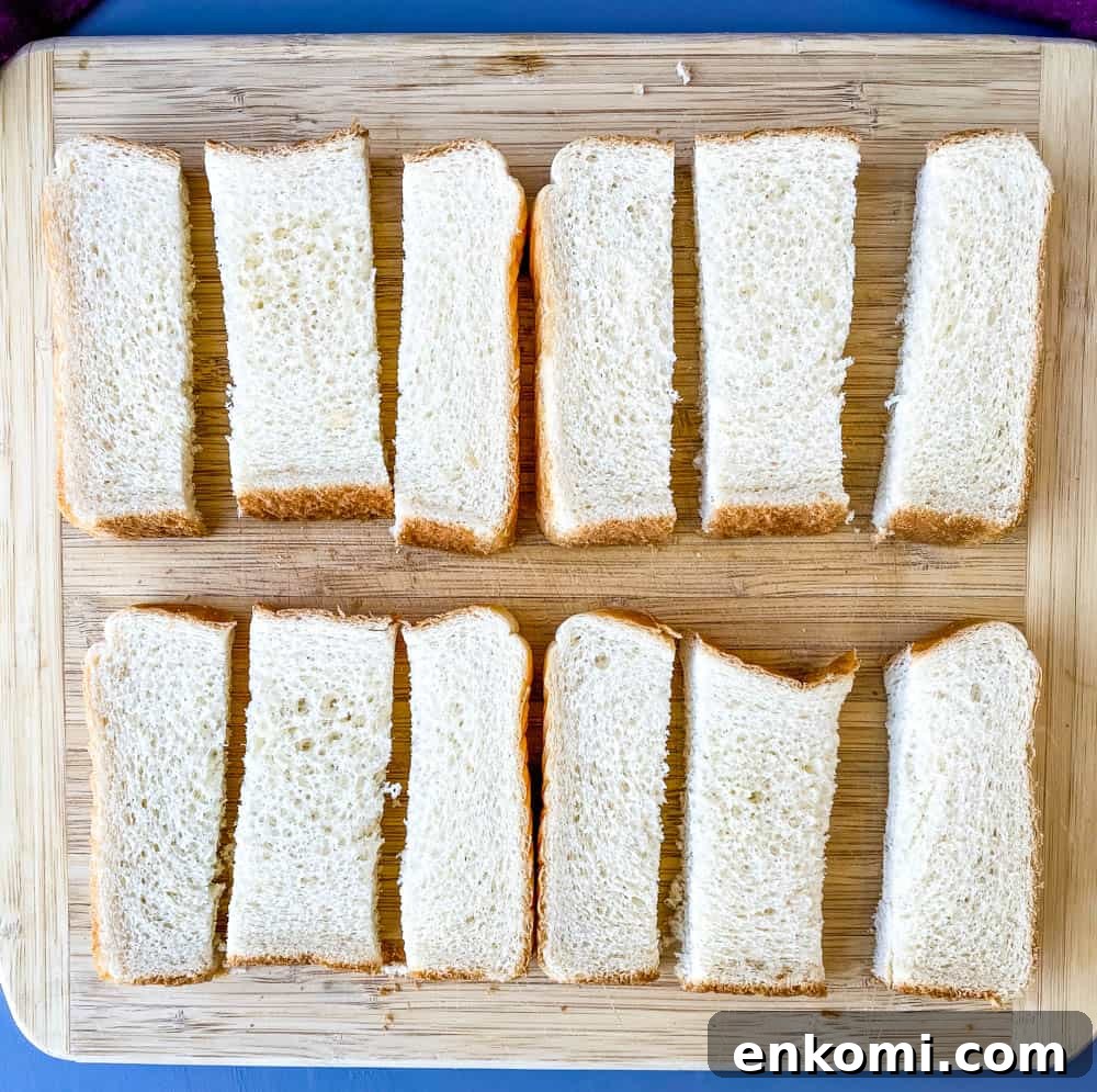 Crispy Air Fryer French Toast Sticks Recipe 5 sliced Texas toast bread on a wooden cutting board