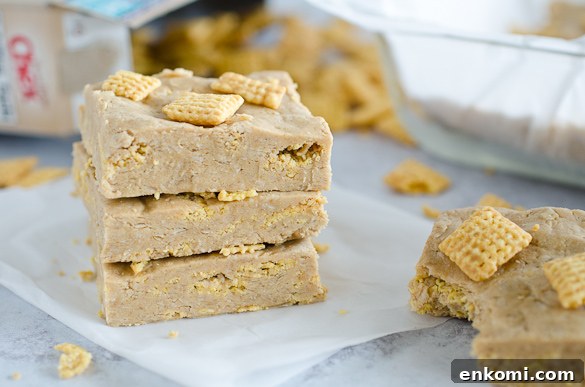 Stack of peanut butter protein bars topped with chex cereal
