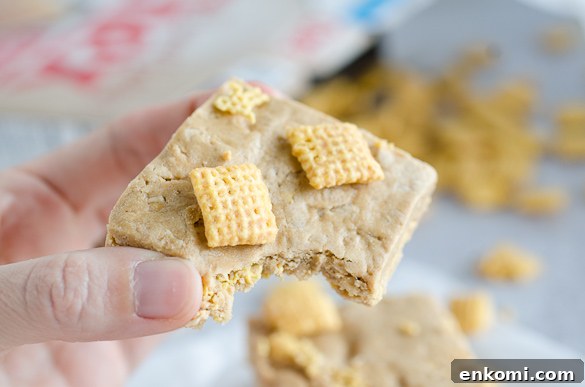 Bite of protein bar with chex cereal.