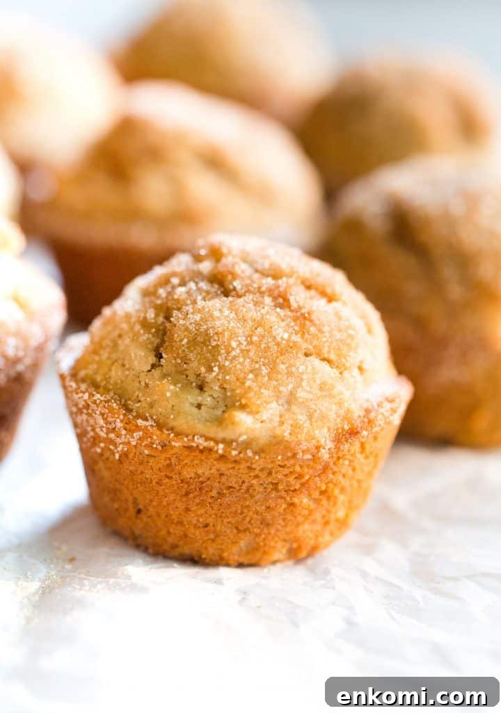 A Maple Muffin on parchment paper with other muffins in the background. 
