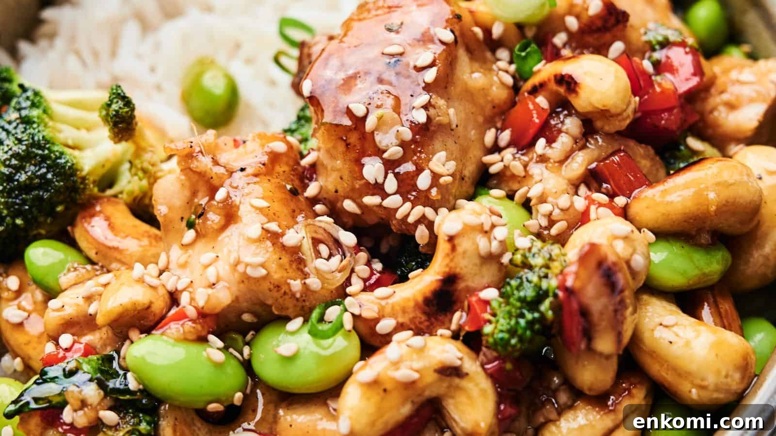 31 Spring Dinners That Feel Fresh, Not Fussy 21 Close-up of Cashew Chicken featuring tender chicken, broccoli, edamame, cashews, and red bell peppers. This delightful dish is topped with sesame seeds and served over a bed of rice.