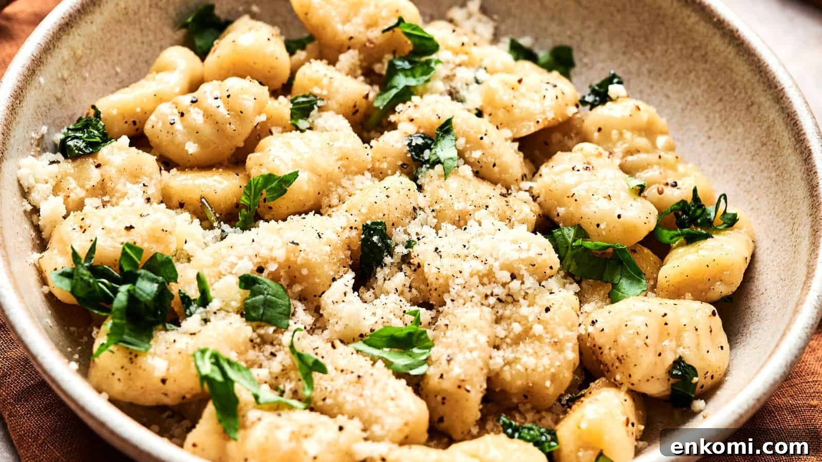 31 Spring Dinners That Feel Fresh, Not Fussy 24 A bowl of gnocchi topped with grated cheese, fresh basil, and black pepper.