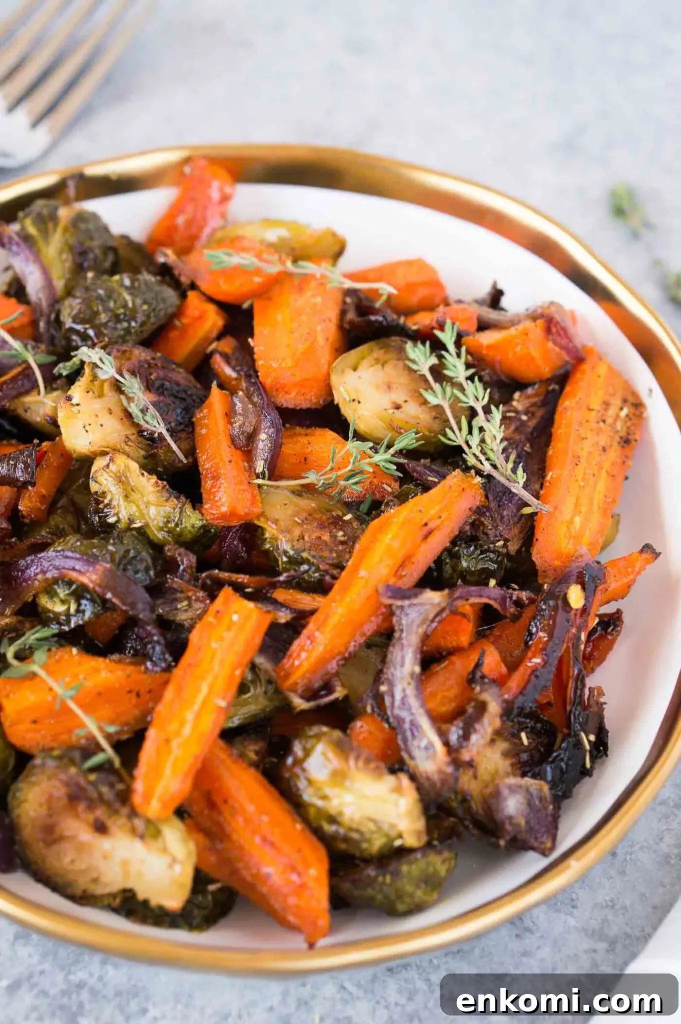 roasted Brussels spouts onions and carrots in a bowl