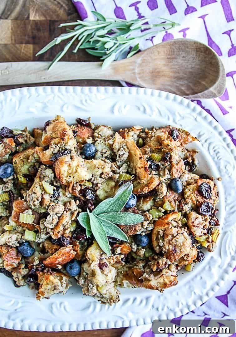 Blueberry Sourdough Sausage Stuffing for Thanksgiving 3 A plate of food on a table, with blueberries and Sausage