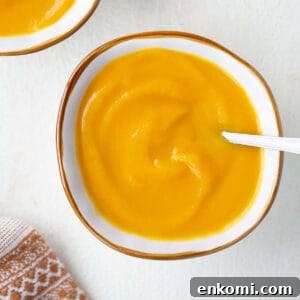 overhead shot of butternut squash soup in bowl with spoon
