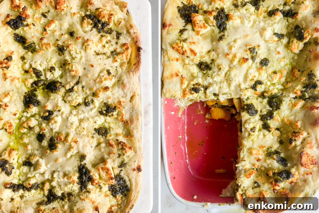 Roasted zucchini and pesto lasagna layered with cream cheese sauce and topped with feta
