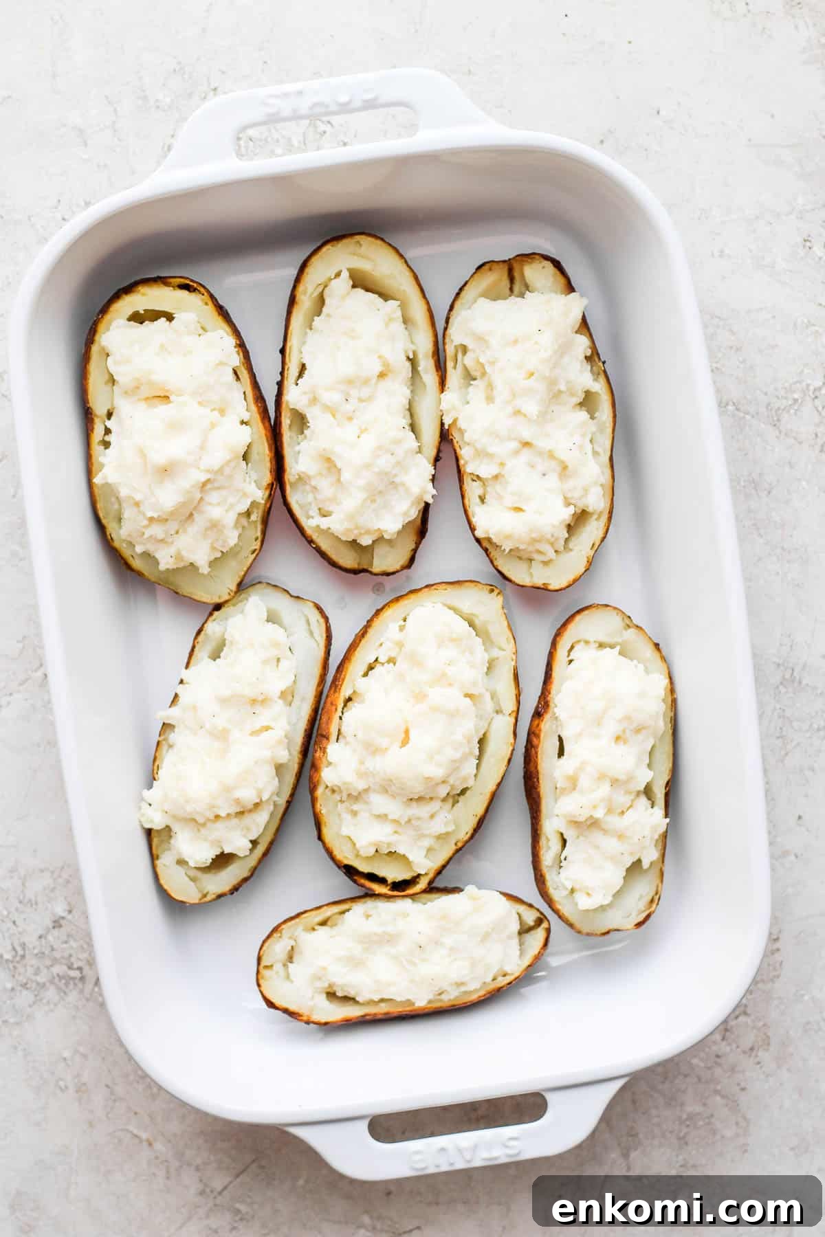 Twice-Baked Potatoes with Cheddar and Crispy Bacon 6 The potato filling added back to the empty potato halves in a large baking dish.